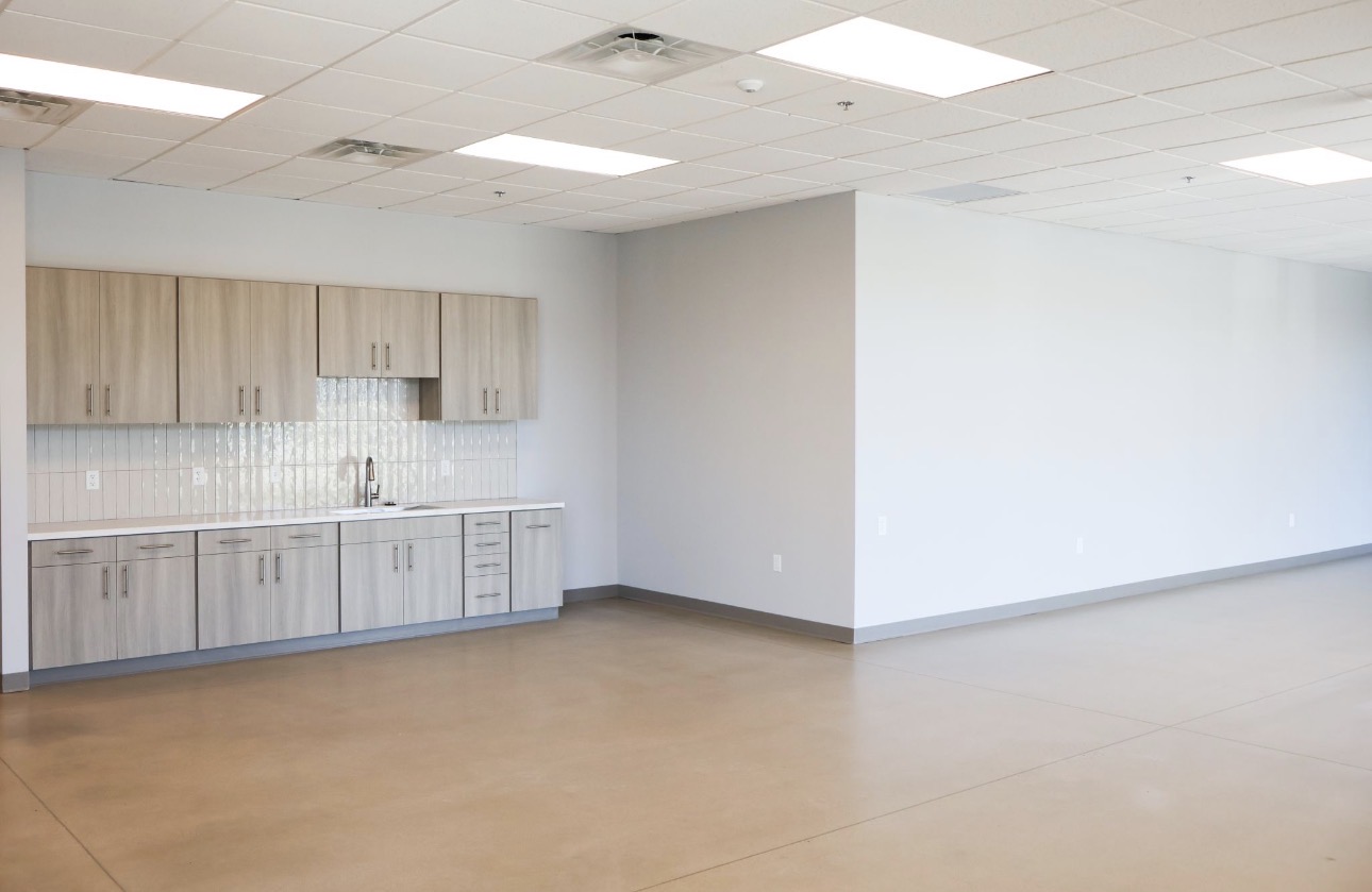 Break area with casework, tile backsplash, and washable finish