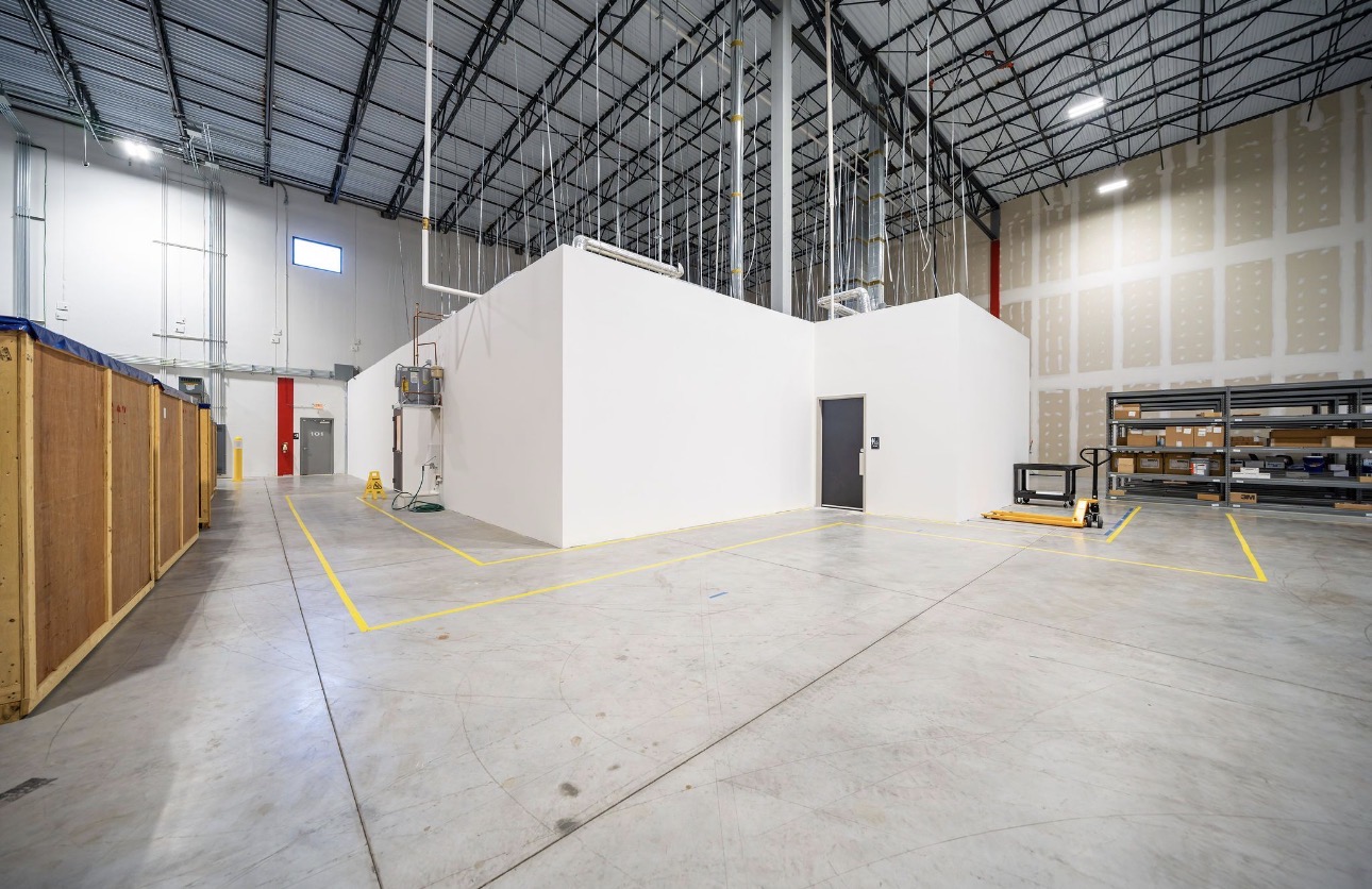 Warehouse buildout with coated walls and sprayed structure