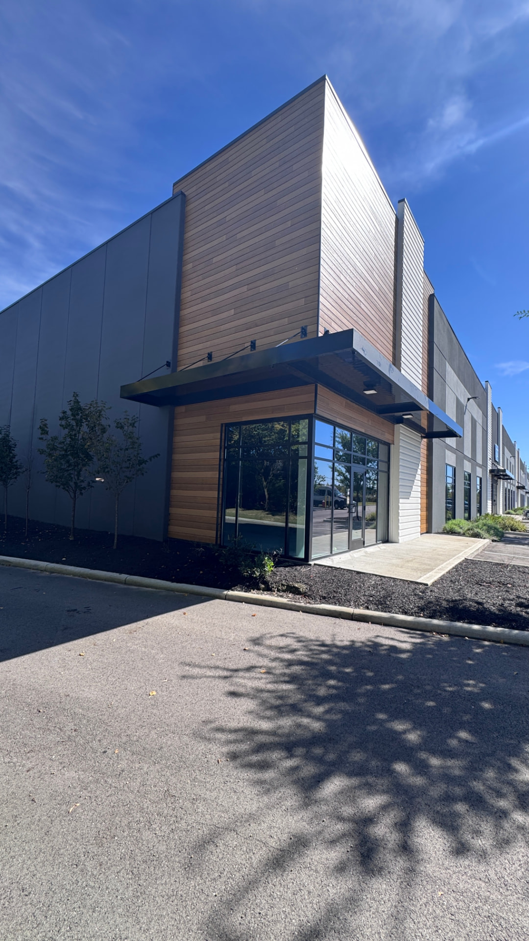 Office corner with canopy and storefront glazing after repaint