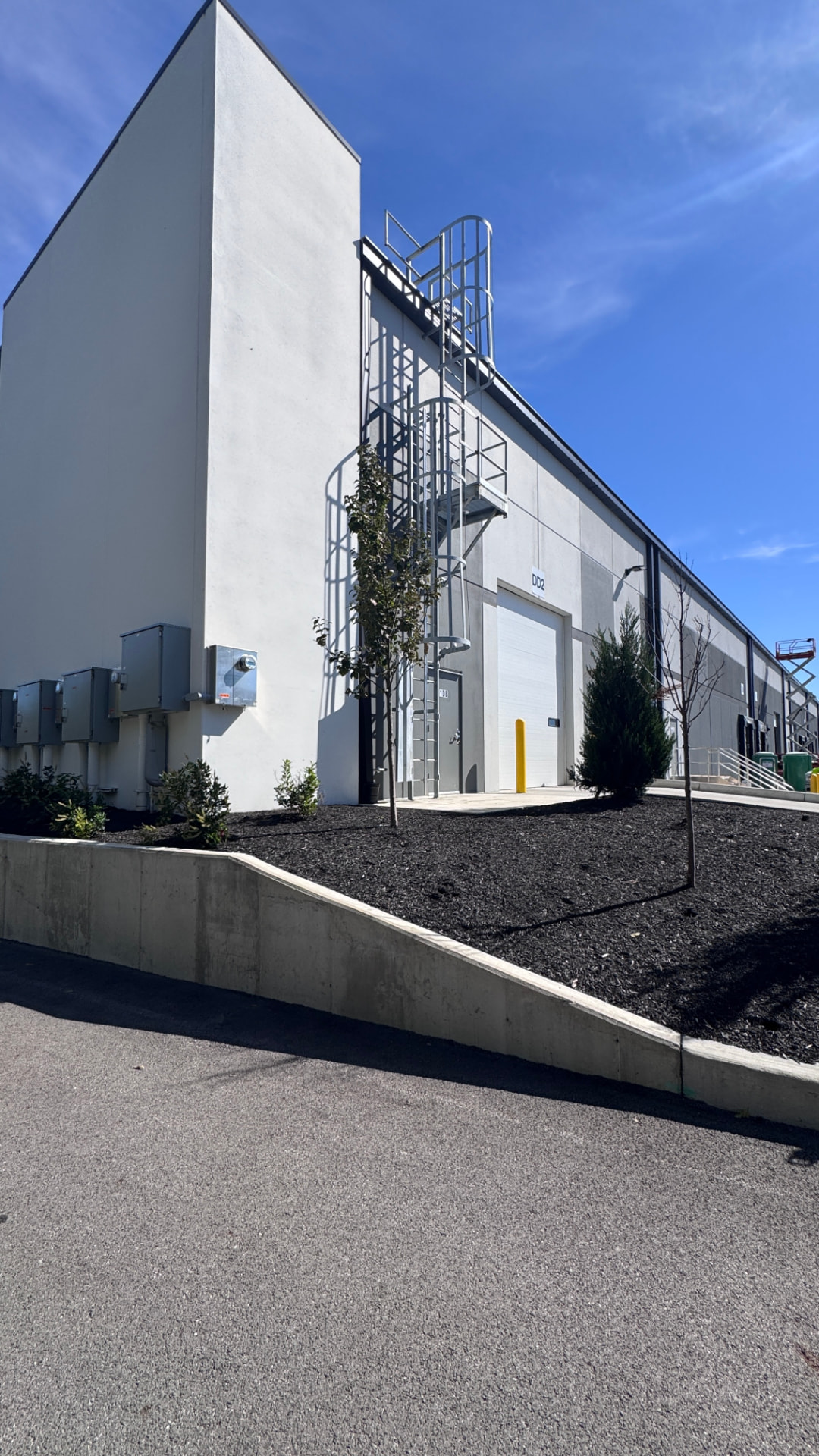 Repainted tilt-up tower and dock elevation with cat ladder at the second facility