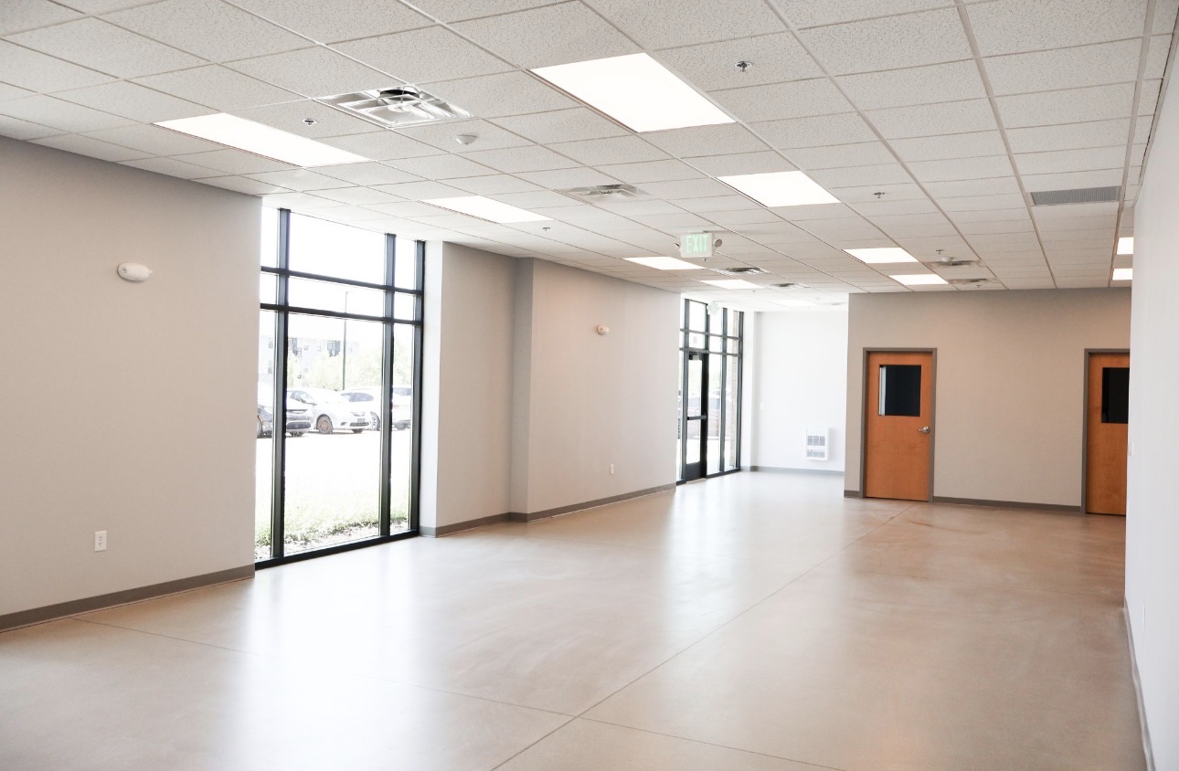 Storefront entry and corridor with finished walls and hollow-metal doors